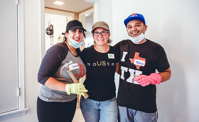 When Sarah Samad (left) and Mohsin Karedia (right) decided to postpone their wedding in the midst of Hurricane Harvey, their wedding planner Kat Creech (center) helped them engage their family and friends in volunteer relief efforts to support local residents affected by the storm.