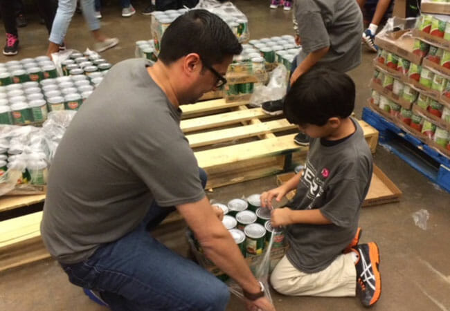 Murad Ajani (left), volunteer president of the Ismaili Council for the Southwestern United States, took a lead role in organizing the volunteers, who helped at local food banks and storm shelters, and helped clean up and repair damaged homes.