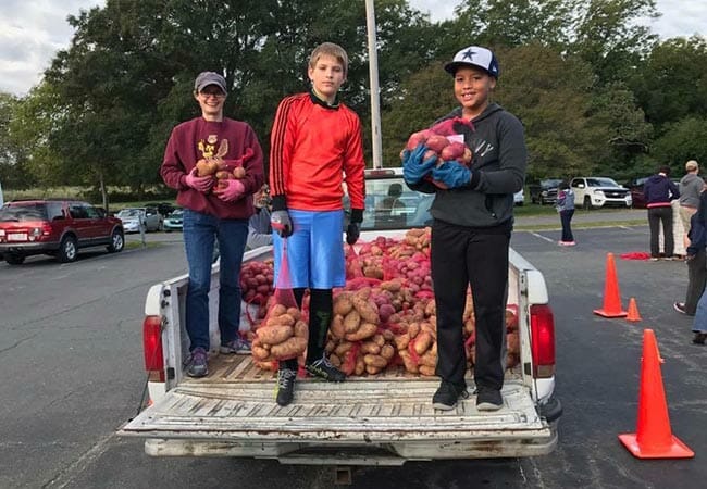 People of all ages and from many different churches came together to sort 37,000 pounds of potatoes into 10-pound bags and distribute them to people in need.