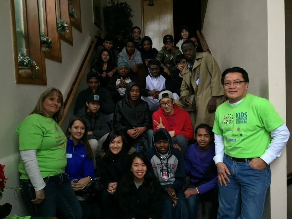 Son Michael (right) at a Kids Without Borders community service project with immigrant and refugee volunteers./Courtesy Son Michael Pham