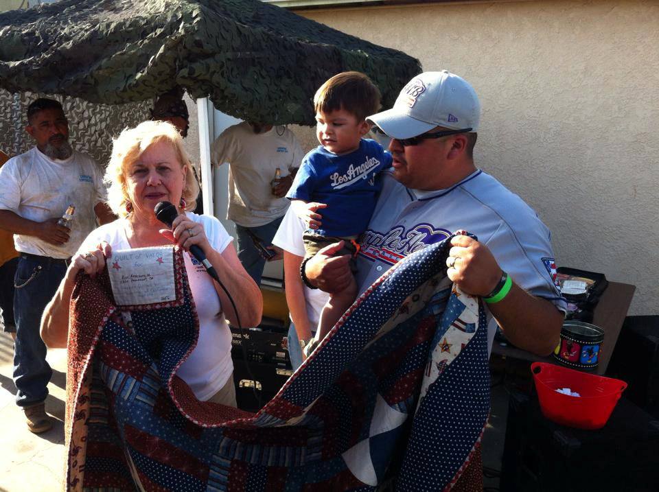 Barbara Winkler presenting a quilt made by SoCal Quilts of Valor to a veteran./Courtesy Barbara Winkler