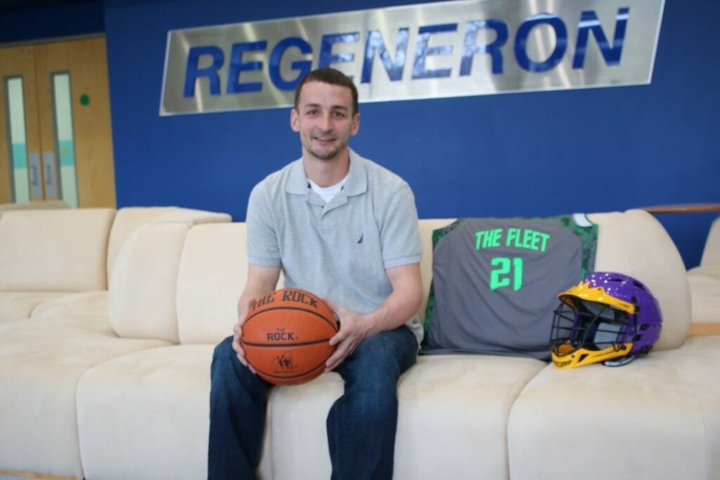 Matt Moller with the travel basketball team jersey and lacrosse helmet representing two youth programs he started in Amsterdam, AAU basketball and Travel Youth Lacrosse./Courtesy Matt Moller