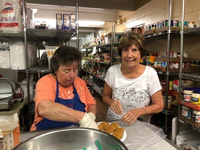 Victoria Frisk (right) helping fellow Wildwood Soup Kitchen volunteer Donna Rissman bag cookies for delivery./Courtesy Victoria Frisk  