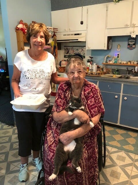 Victoria delivering a meal to Norma McNeal, who volunteers as a pianist at a local nursing home./Courtesy Victoria Frisk