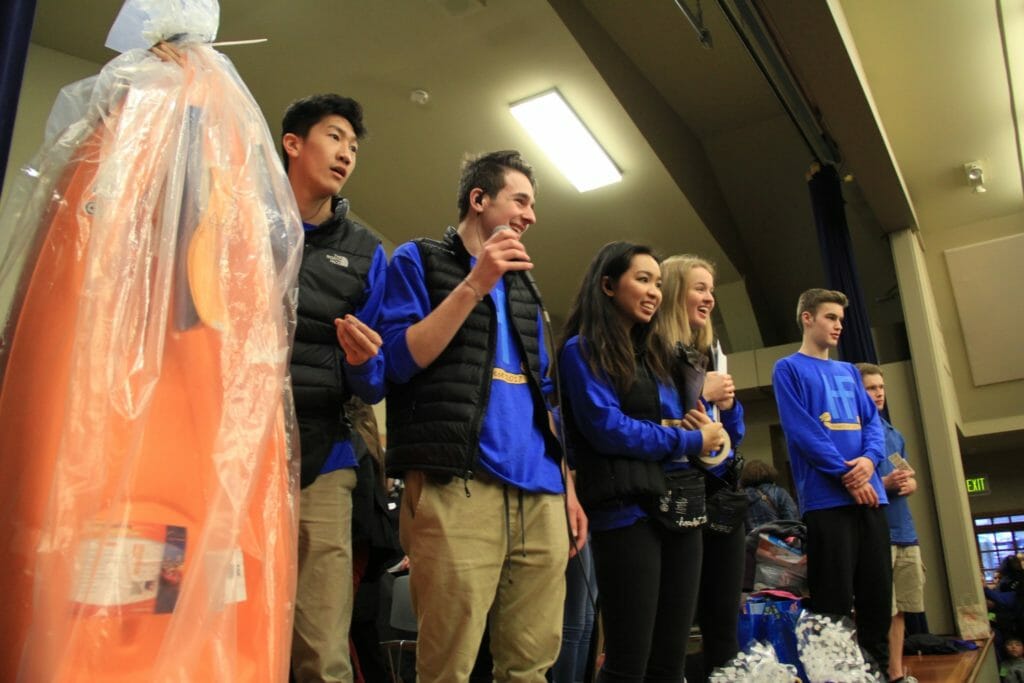 Mai (center) announcing the winner of a canoe at a fundraising raffle./Courtesy Mai Nguyen