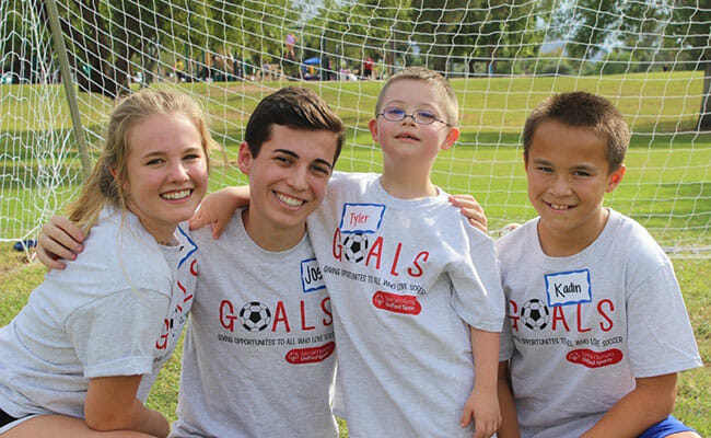 Josh Kaplan, along with friends Emma, Tyler, and Kaden, participate in a GOALS soccer scrimmage. GOALS provides athletes with intellectual disabilities the opportunity to pair up with neurotypical peers and play on a soccer team.