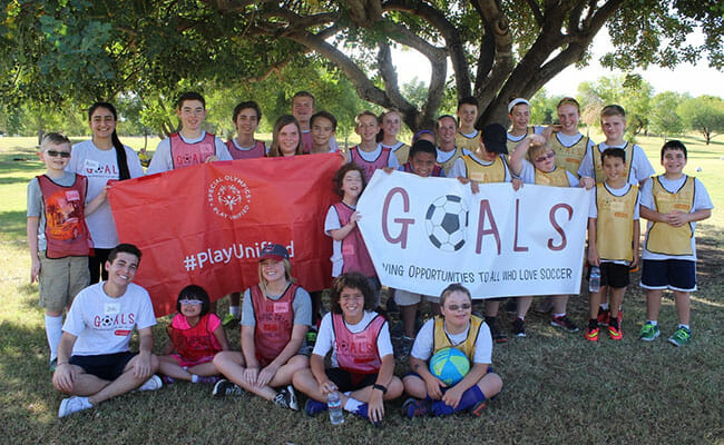 Two GOALS teams gather together for a picture during half time.