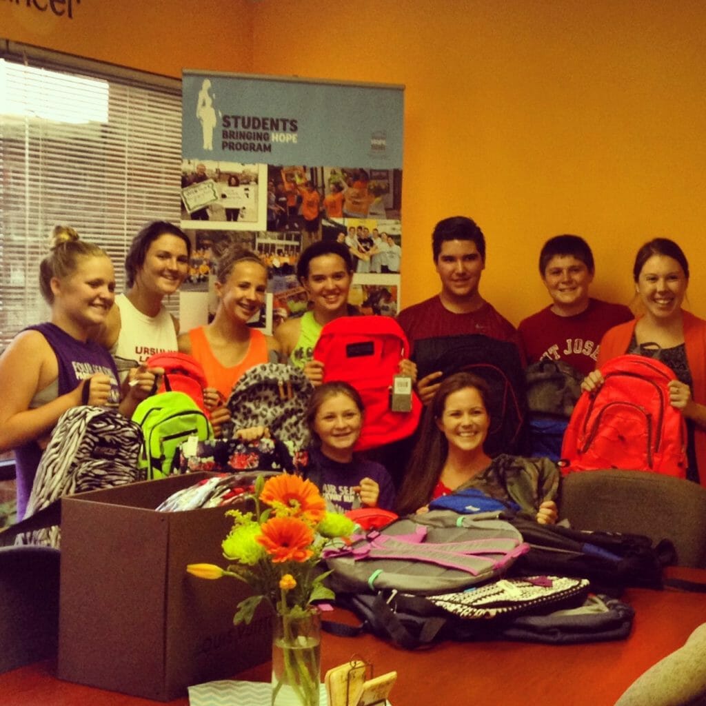 Nick (back row, third from right) joing volunteers at Bringing Home Home to pack backpacks with school supplies./Courtesy Nick Moncilovich