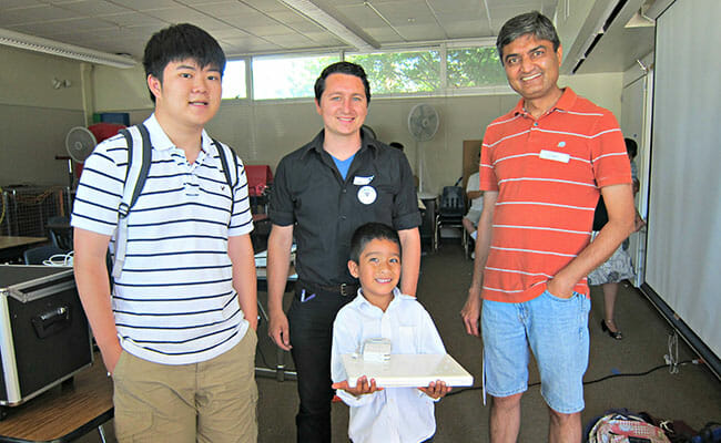 Working with EqOpTech partner Sunday Friends, Terence Lee (left) delivered a refurbished MacBook to a disadvantaged child to give him the opportunity to  begin learning STEM at an early age. 