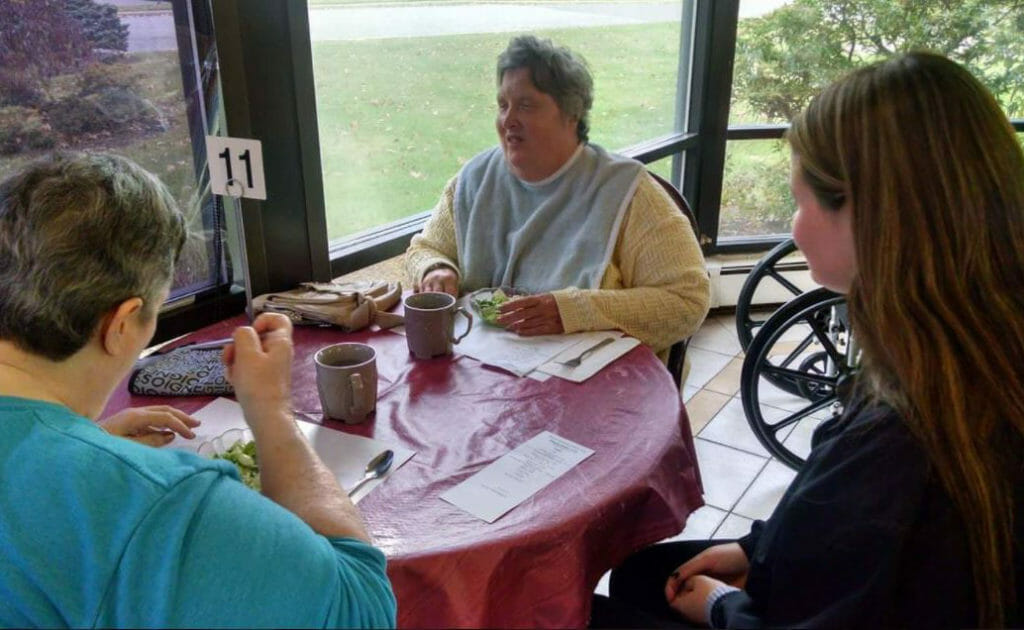 G.R.A.M.M volunteer Alexa, a local college student and musician, visits with twin sisters Claudia and Christine. Both blind, the sisters play the cello and flute, and enjoy playing music with Alexa.