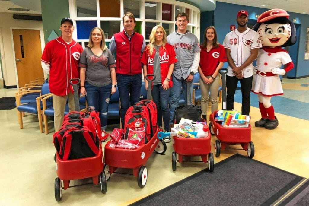 Abigail (second from left) delivers wagons to the Dayton's Children's Hospital with Red Wagon Campaign partners from the Cincinnati Reds, who visit the hospital once a year to meet with patients and hand out team gear./Courtesy Abigail Brown 