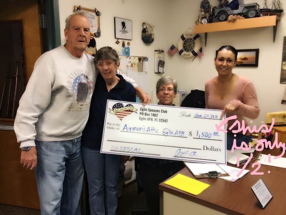 Cynthia (far right) being presented with a donation for Airman's Attic at Eglin Air Force Base./Courtesy Cynthia Sluka