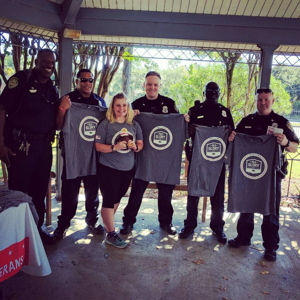 Thea pictured with members of the Houston Police Department who provided an escort during Team Red, White & Blue's Old Glory Relay./Courtesy Thea Ward Jorgensen