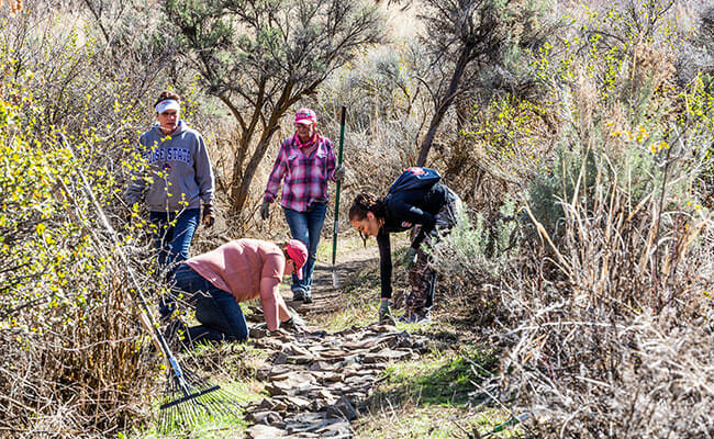 Clif Bar employees in Twin Falls, Idaho, rebuilding trails and picking up trash during the Companywide Service Day at Centennial Park.