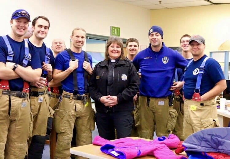 Chaplain Diane Peterson (center) pictured with local firefighters at a Coats for Kids event in Anchorage, Alaska./Courtesy Shiloh Powell