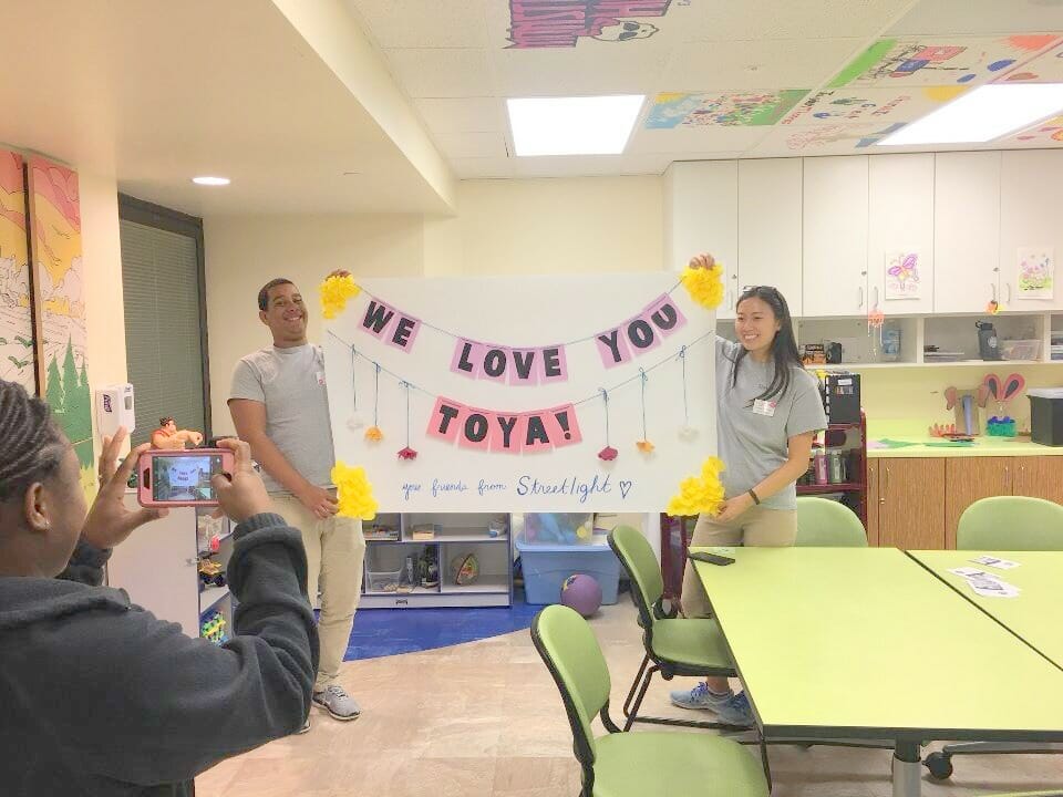 Jordy (left) and a friend are celebrating a patient’s recovery by making her a poster to remind her that she is loved and should continue fighting/Courtesy Jordy Botello 