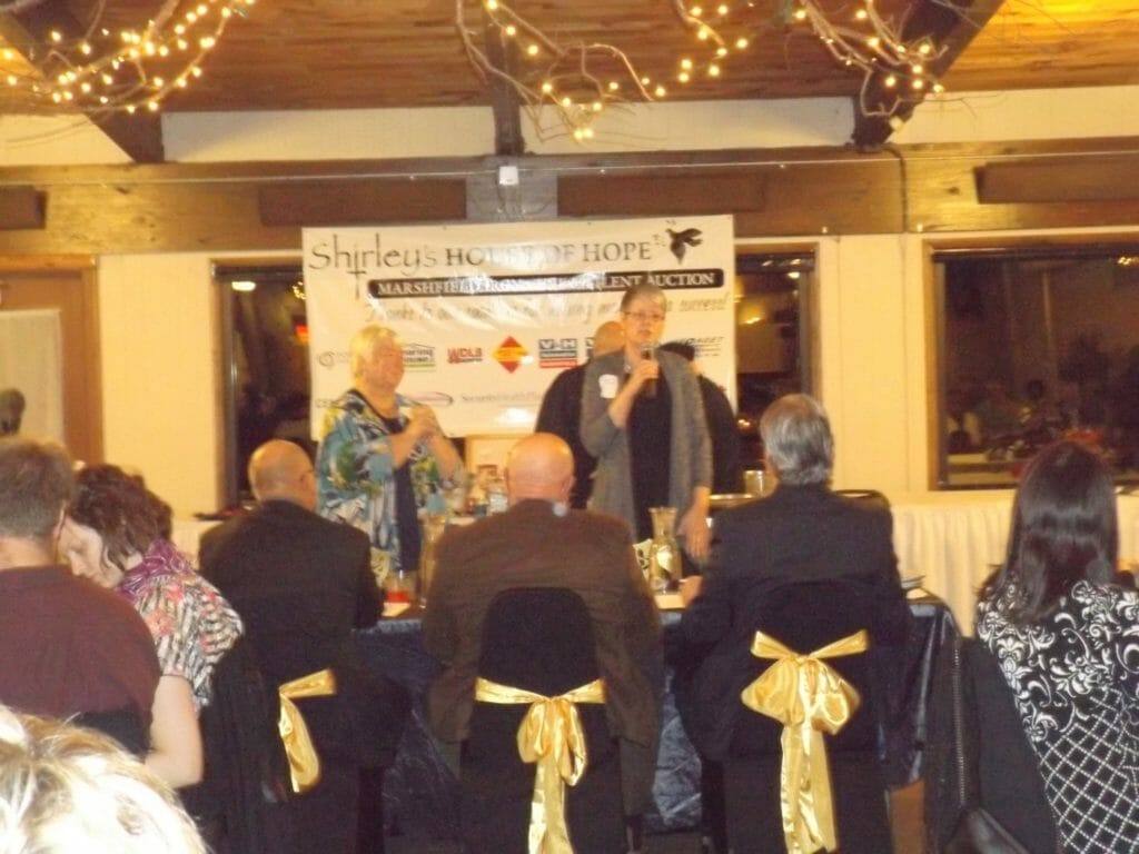 Shirley’s House of Hope co-founders, Sue Poole (left) and Julie Cravillion (right) speak at the annual Iron Chef event./Courtesy Julie Cravillion