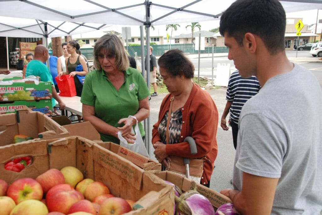 Joyce (left) helps some Feed My Sheep friends pick out fresh produce/courtesy Joyce Kawakami