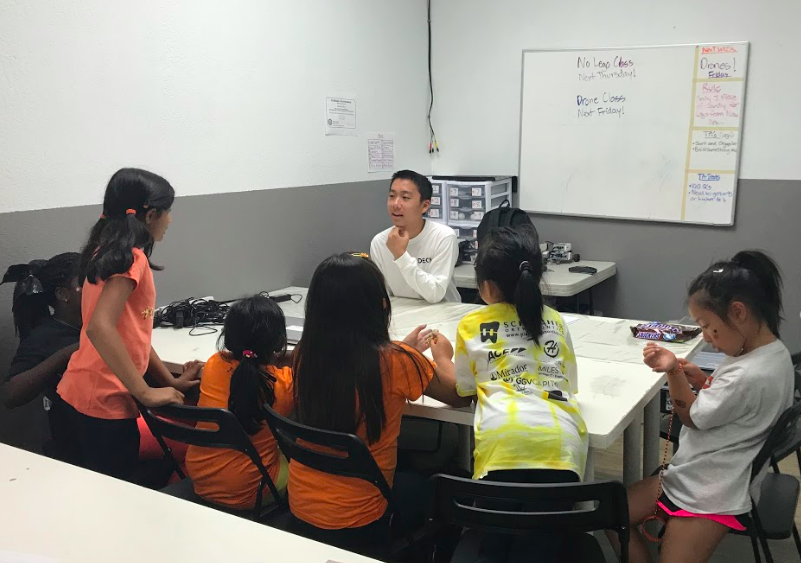 TakeOff's co-founder, Ashton Lam (center) hosting a mini-workshop on entrepreneurship to elementary schoolers at the Young Ivy Academy./Courtesy Ashton Lam