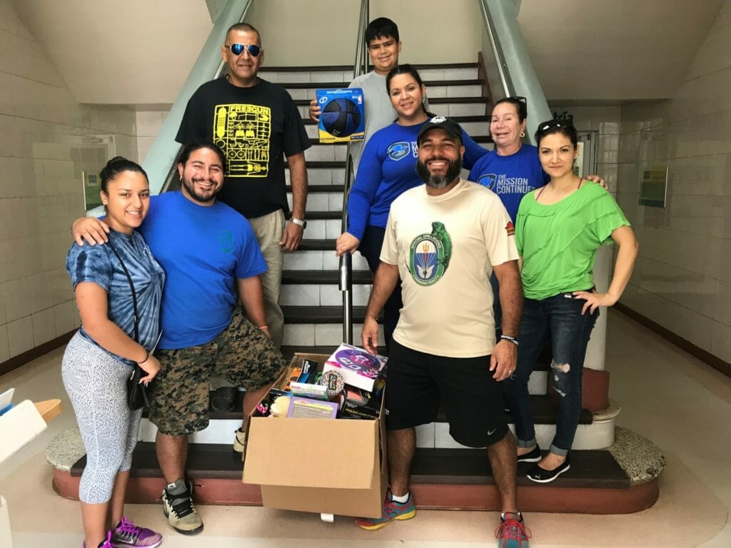 Gabriela (far left), her family and volunteers at a local hospital, preparing to give out donated toys./Courtesy Gabriela Auguste