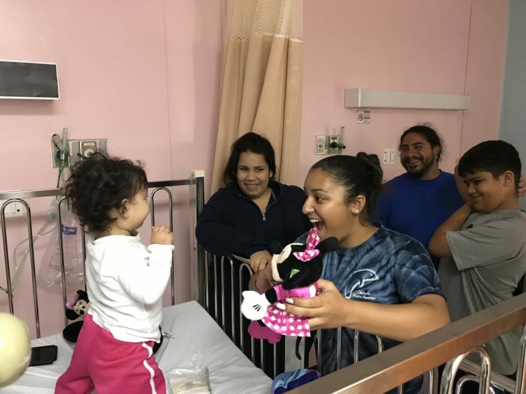 Gabriela visiting a children's hospital with donated gifts./Courtesy Gabriela Auguste