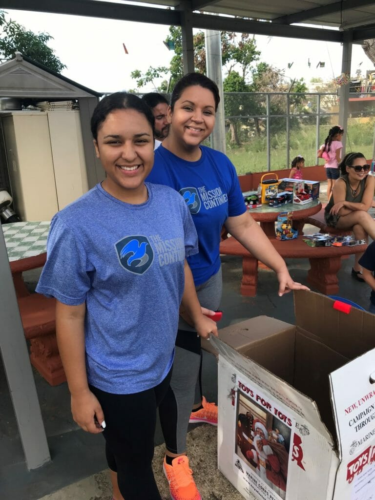 Gabriela (left) and her mother, organizing gifts to give at an orphanage./Courtesy Gabriela Auguste