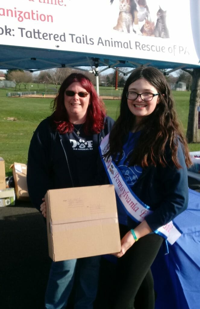 Catherine Olsen (right)  holding a small delivery of supplies delivered to Tattered Tails Animal Rescue of PA. at the Pups for Pulmonary Fibrosis charity event in Bethlehem, PA./Courtesy Catherine Olsen