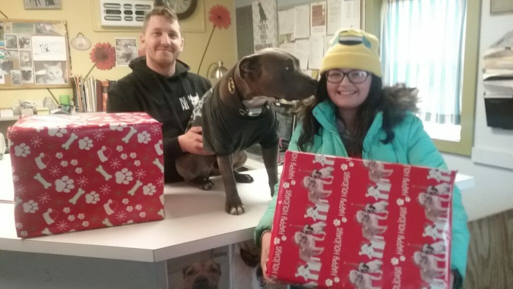 Catherine Olsen delivering “Santa Boxes” to  shelters and getting a thank you kiss!/Courtesy Catherine Olsen