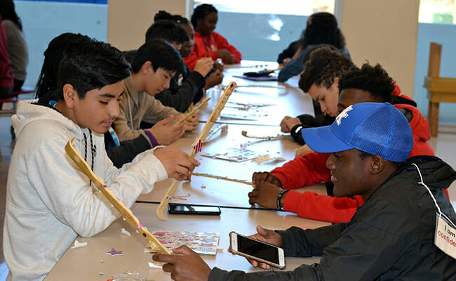 Teens participate in a service project at the 2017 Be The Change Youth Summit.