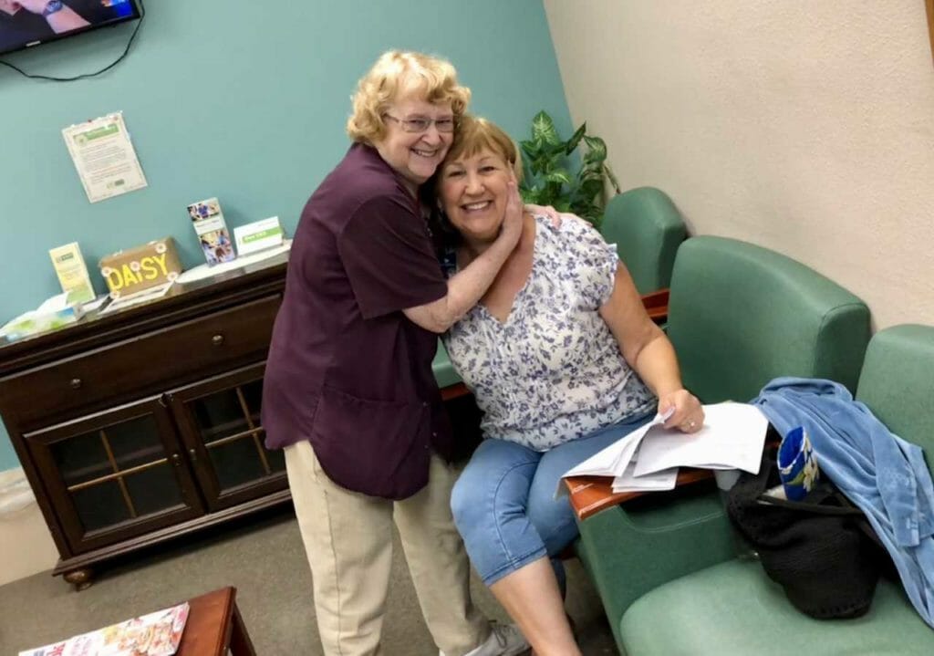 Clara Bernard (left) visiting with a patient's spouse./Courtesy Banner Payson Medical Center