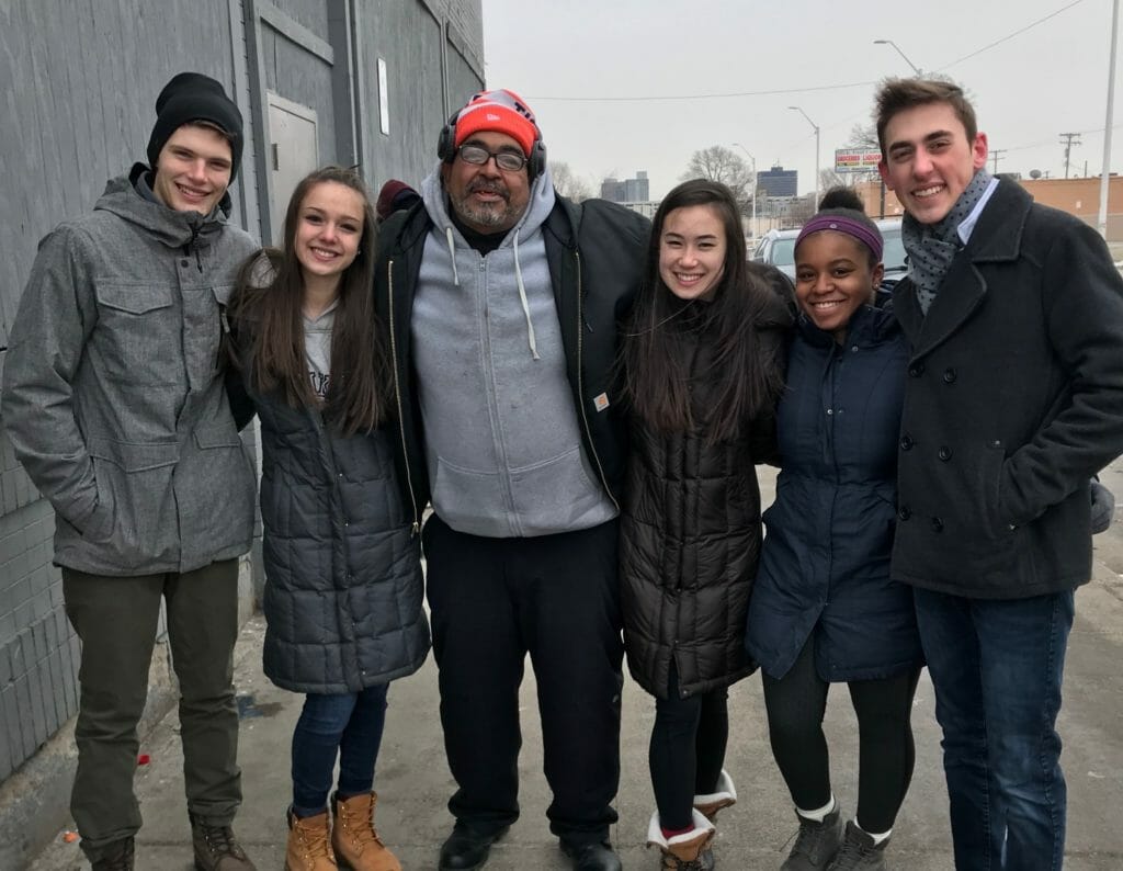 Quinn Favret (far right) and Support 313 members distributed hats and gloves in February./Courtesy Quinn Favret