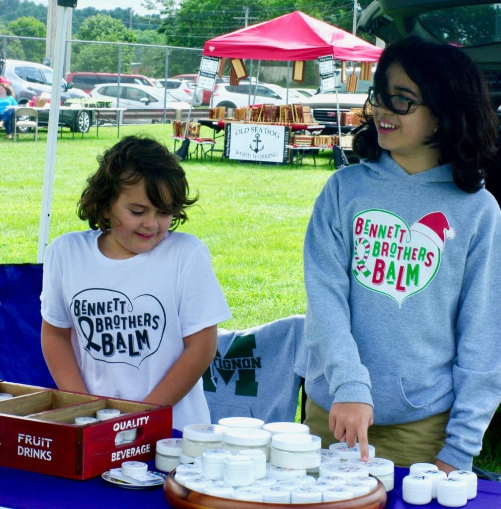 Heath (left) and Harry (right) working the Bennett Brothers Balm booth at a local fair./Courtesy Bennett Brothers Balm