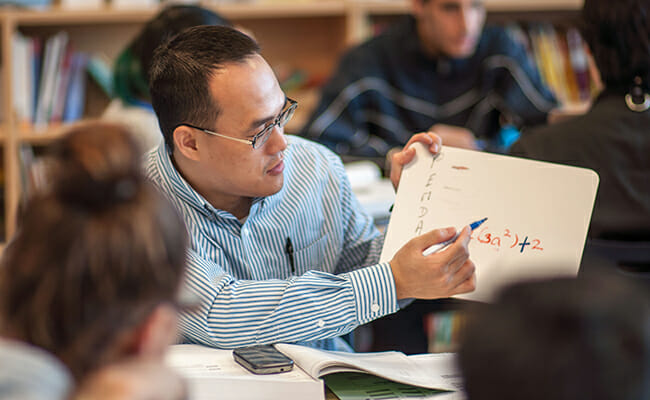 New York Cares volunteer gets high school students prepared for the SAT through the College Access program. 