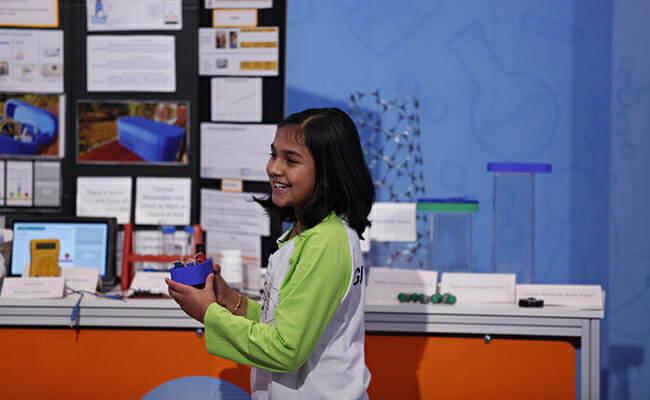 Gitanjali Roa presents her newest edition of Tethys, her lead detection invention (photo courtesy of Discovery Education 3M). 