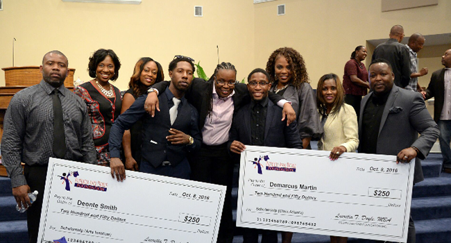 Lucretia Doyle, center, and PAD Foundation board members award scholarships to students who have a currently or formerly incarcerated parent. 