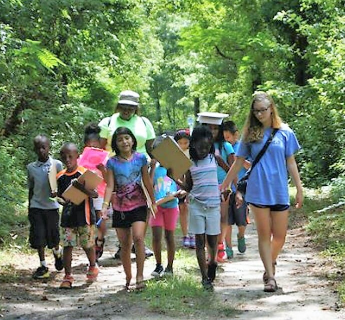Brittany Turner (far right) leads a group of children attending Love a Sea Turtle summer camp on a nutrition scavenger hunt./ Brittany Turner
