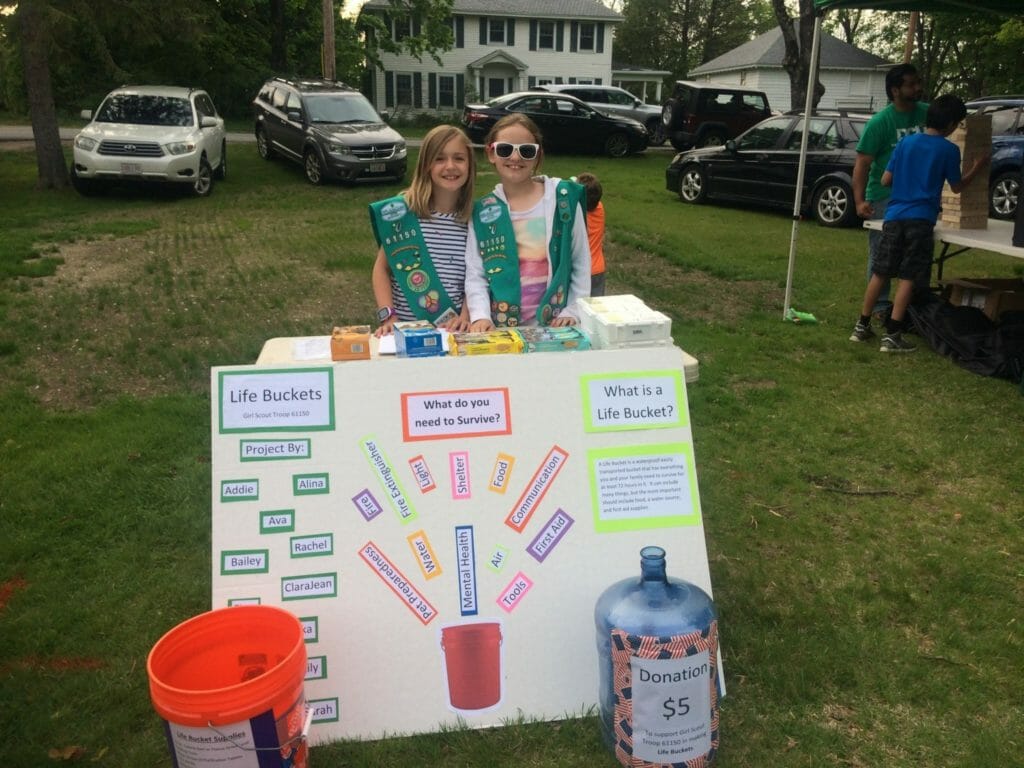Rebecca Fusco and her friend Lily Tesz worked together to bring the Life Bucket Project to life.  Here they are at a Littleton town event offering tips on emergency preparedness./ Courtesy Rebecca Fusco