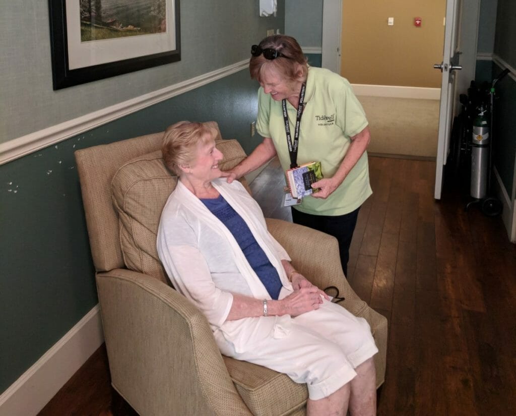 Carol Iddings offering comfort, a donated lap quilt and smiles at the Tidewell Hospice House in Port Charlotte, Florida./ Courtesy Carol Iddings 