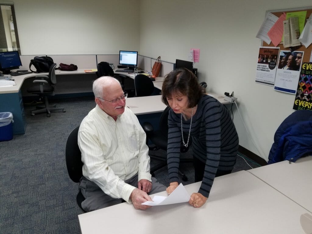 Ildiko Schultz (right) with a volunteer coach discussing one of their new clients. /Courtesy Ildiko Schultz 