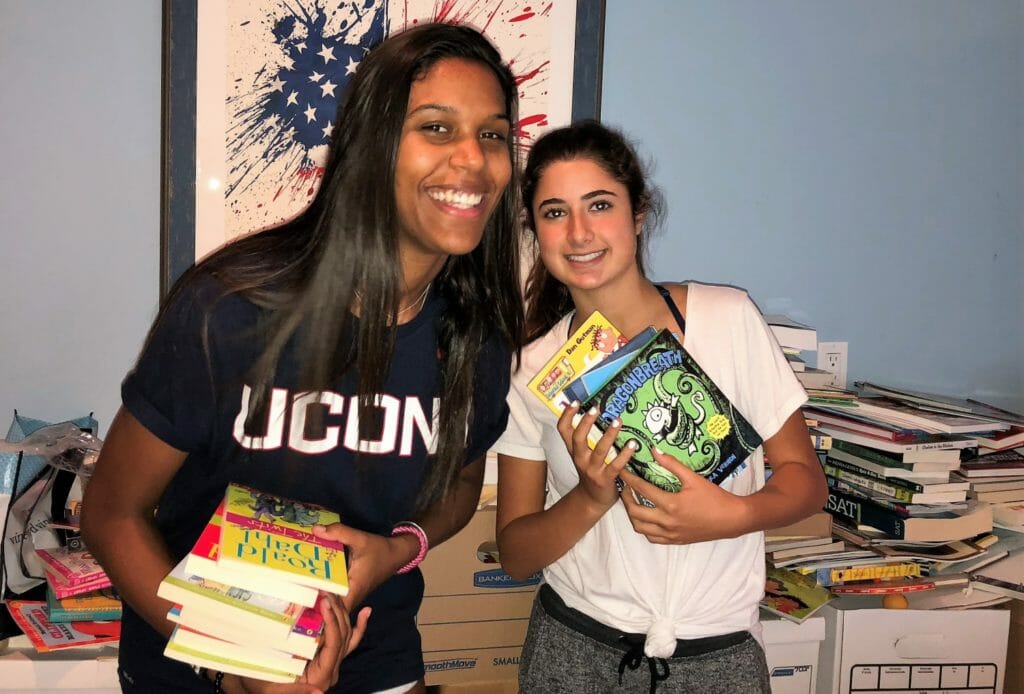 Reading Reflections president Eden Schneck (right) and Tamara Hyman, a student at American Hebrew Academy in Greensboro, N.C., provide books for the Greensboro community after severe tornado damage./Courtesy Eden Schneck
