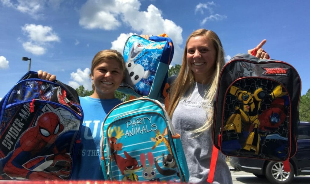 Sami (right) pictured at backpack delivery day, where Hugs Across the Country supplied about 25 kids with brand new backpacks and school supplies before the beginning of the school year./ Courtesy Sami Meyer