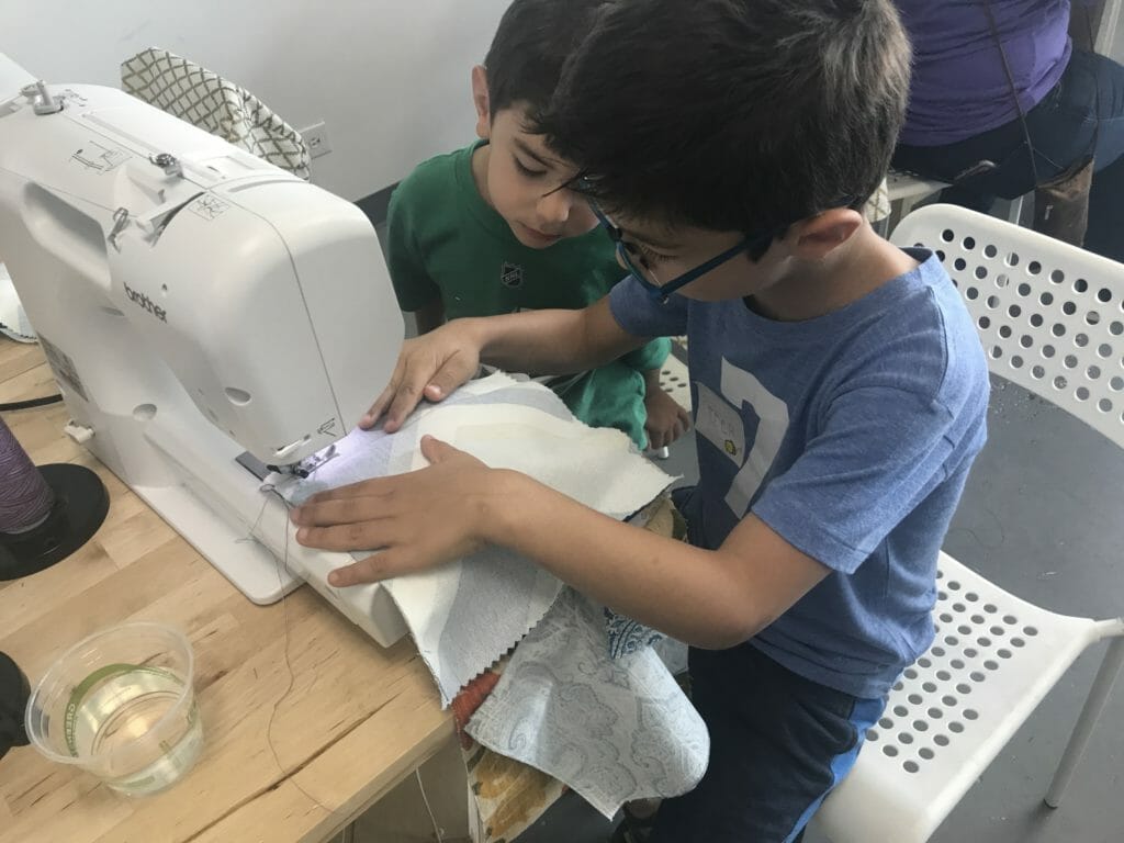Peter and Simon sewing blankets for pediatric patients./ Courtesy Tanya Polsky