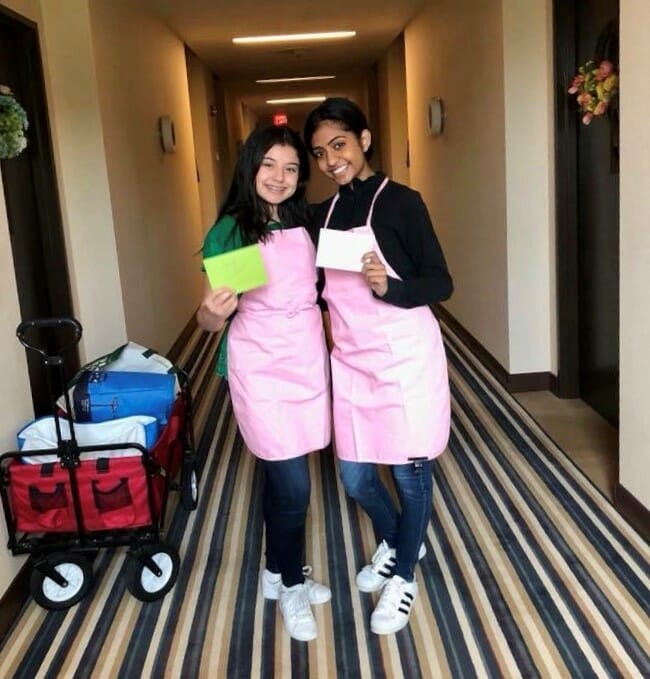 Cayla and another volunteer delivering treats to children in the hospital./Courtesy Cayla Kumar 