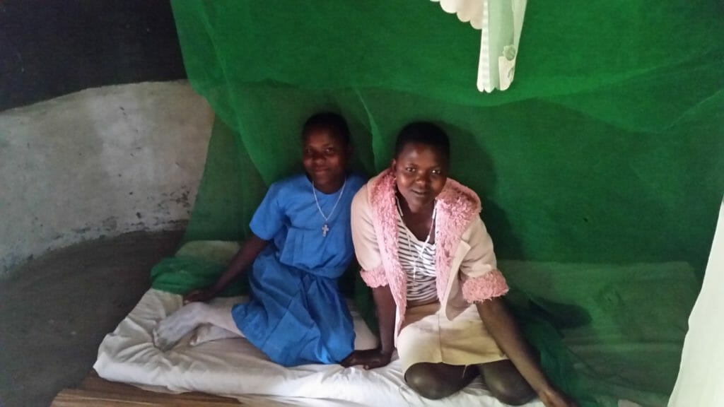 Two of the young girls in Uganda who have received mosquito nets from  NETwork Against Malaria./ Courtesy Mary Claire McGlynn
