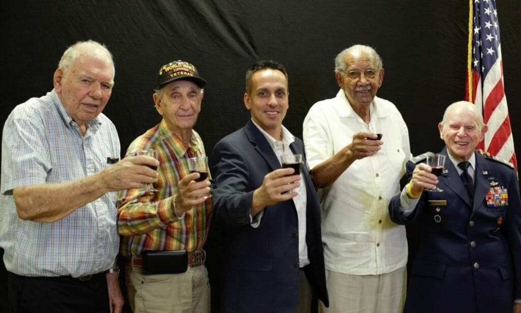 Paton holds up a toast with some of the veterans involved with Honor Flight South Florida, an organization that flies older veterans to visit memorials in Washington, D.C. /Courtesy Ryan Paton