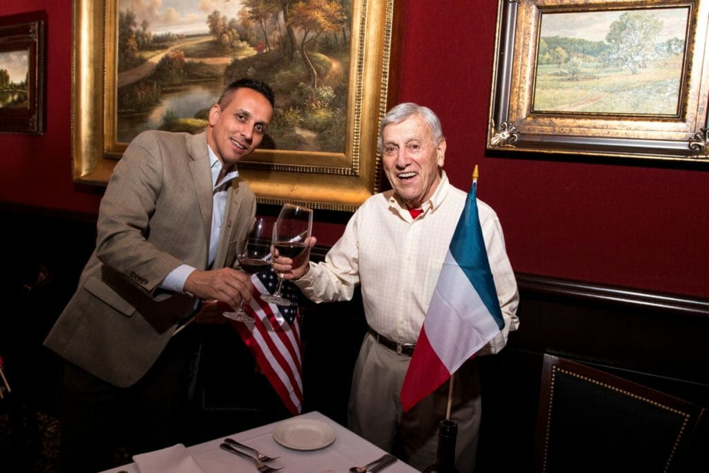 Paton stands with a veteran honored by Honor Flight South Florida. Twice a year, Paton holds Cocktails with Heroes, a fundraising event to honor the veterans. /Courtesy Ryan Paton