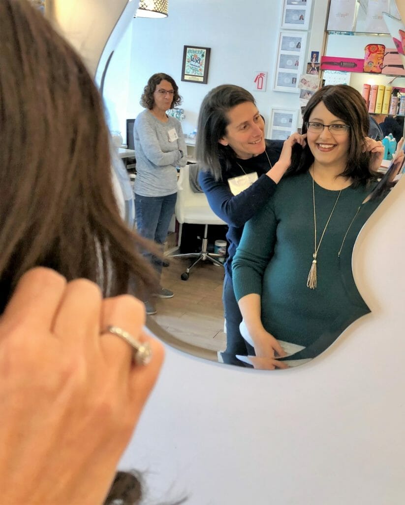 Sandy Samberg helps a client adjust a wig, which she received through Soul Ryeders’ Wig Exchange Program.  Wigs are donated by former cancer patients, reconditioned, and donated to women undergoing chemotherapy./ Courtesy Sandy Samberg