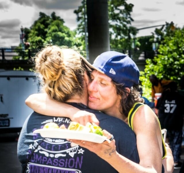 Melissa Mayne (l) shares a hug with Danielle, a formerly homeless woman who is now enrolled in college and a Compassion Highway Project volunteer./Courtesy Melissa Mayne