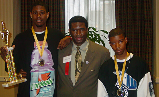 Orrin Hudson, center, at the Georgia State Championships with students Aaron Porter and Xavier Graham. Orrin founded Be Someone to help teach at-risk youth critical life skills through the game of chess.