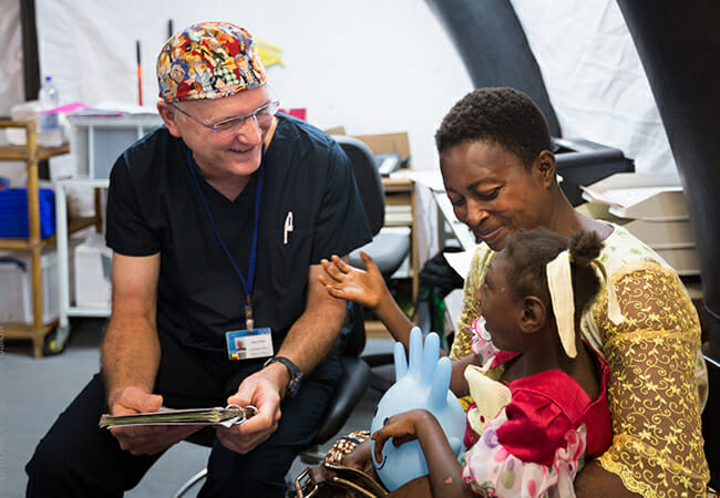 Dr. Gary Parker talks with an Africa Mercy ship patient. /Courtesy Mercy Ships